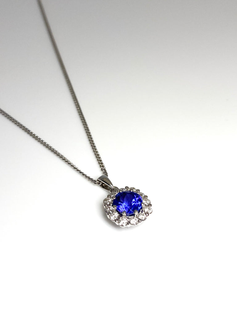 18CT WHITE GOLD 1.06CT TANZANITE AND 32PT DIAMOND HALO PENDANT