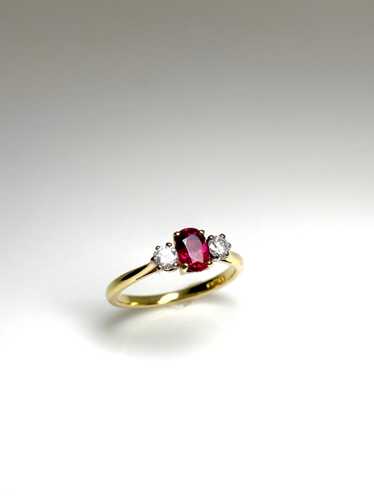 18CT GOLD OVAL 50PT RUBY AND 25PT DIAMOND TRILOGY RING