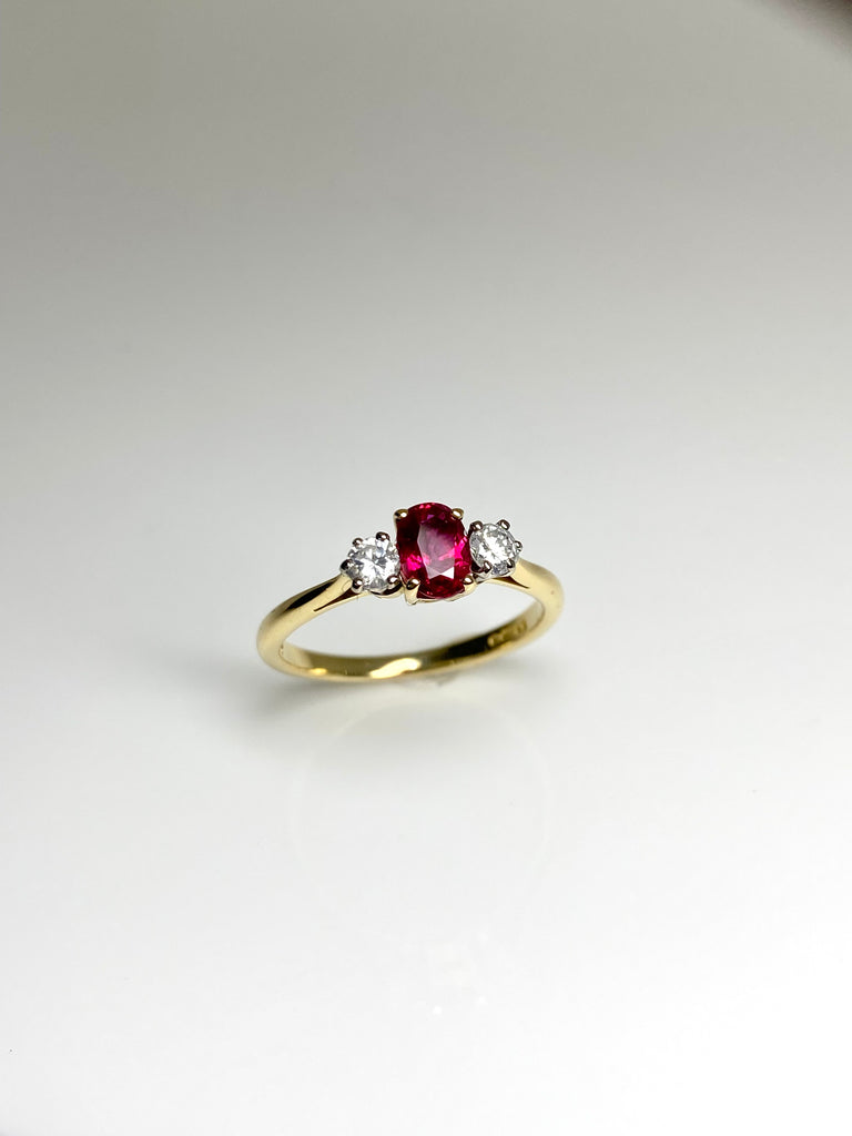 18CT GOLD OVAL 50PT RUBY AND 25PT DIAMOND TRILOGY RING