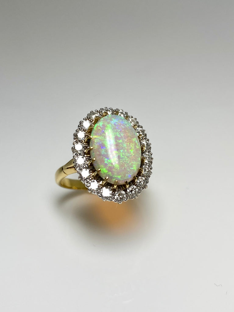 18CT 5.00CT CRYSTAL OPAL AND 1.00CT DIAMOND CLUSTER RING