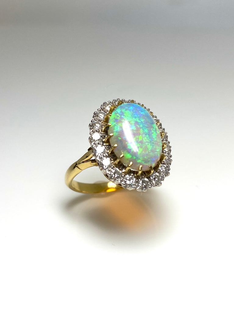 18CT 5.00CT CRYSTAL OPAL AND 1.00CT DIAMOND CLUSTER RING