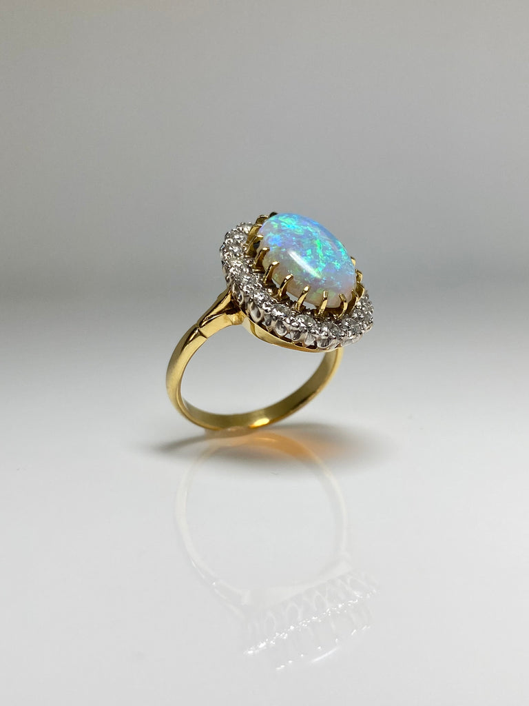 18CT 5.00CT CRYSTAL OPAL AND 1.00CT DIAMOND CLUSTER RING