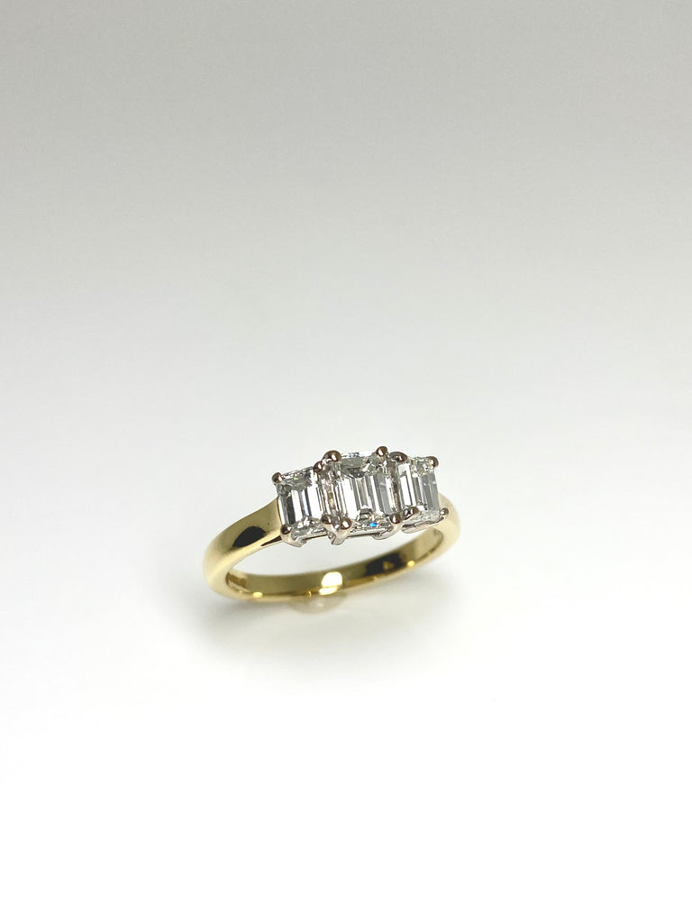 18CT YELLOW GOLD 1.25CT EMERALD CUT 3 STONE DIAMOND RING