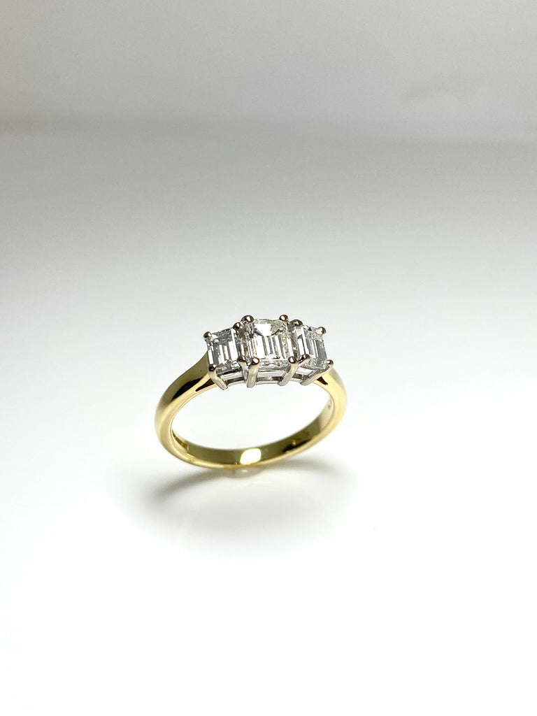 18CT YELLOW GOLD 1.25CT EMERALD CUT 3 STONE DIAMOND RING