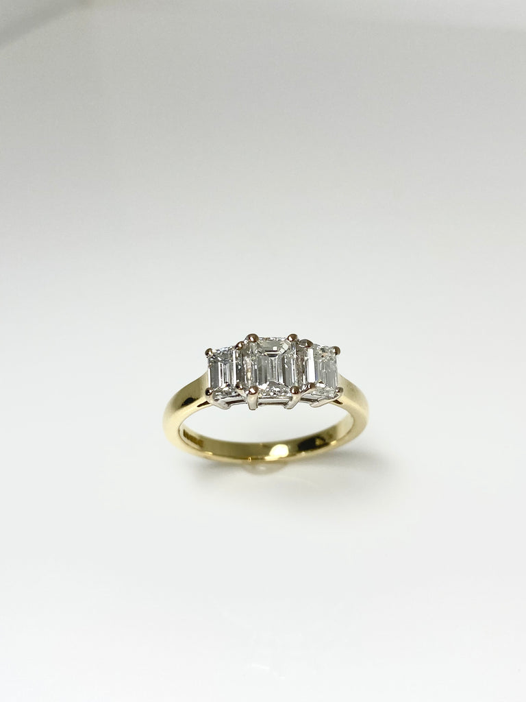 18CT YELLOW GOLD 1.25CT EMERALD CUT 3 STONE DIAMOND RING