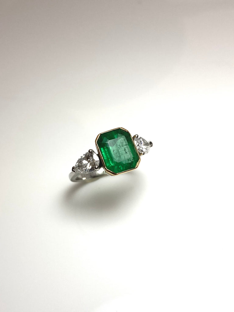 PLATINUM 3.28CT EMERALD WITH PEAR SHAPED DIAMONDS TRILOGY RING